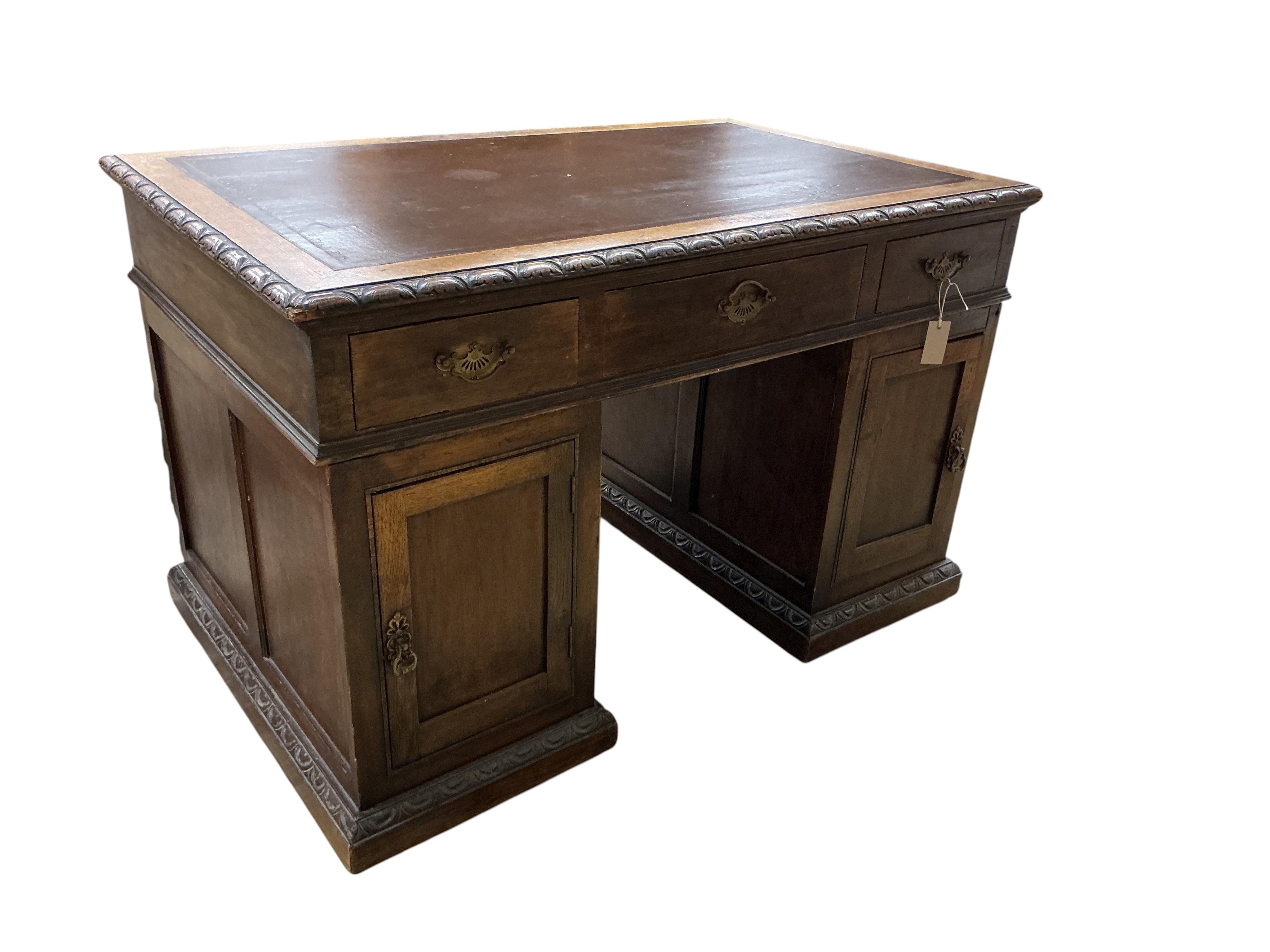 A late Victorian Flemish carved oak pedestal partners desk, width 121cm, depth 75cm, height 76cm